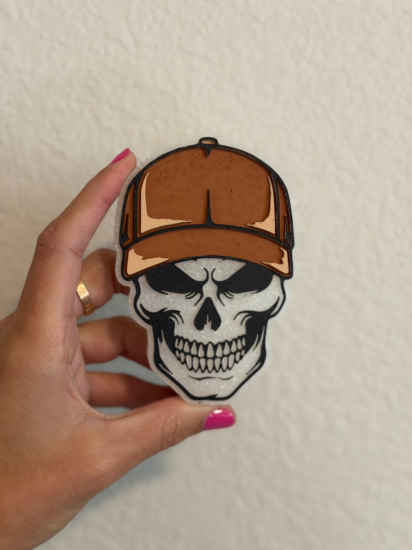 Skull with brown trucker hat